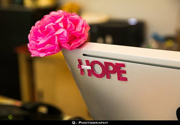 A pink decorative flower and glittery pink letters spelling "HOPE" are attached to the corner of a computer monitor, creating a charming touch reminiscent of Josephine's Day Spa.