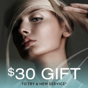Close-up of a woman with light hair and a focused expression, alongside text: "$30 Gift to Try a New Service*." Discover the magic of Olaplex hair treatments or explore new balayage and highlights options today!.