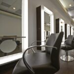 eldridge-10-square Experience luxury at Houston’s premier Aveda salon and spa—modern interior, elegant black styling chairs, illuminated mirrors, and rich wood floors for a relaxing beauty retreat. | Josephine's Salons and Spas | Houston, TX
