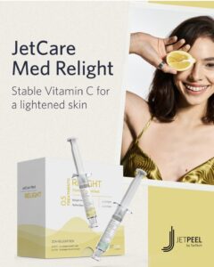 Smiling woman with lemon slice over one eye; JetCare Med Relight vitamin C, skin syringes. Houston luxury Aveda spa skincare. | Josephine's Salons and Spas | Houston, TX