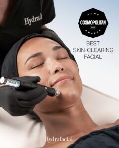 A client enjoys a luxury Hydrafacial at a Houston Aveda salon and spa, performed by a gloved expert. Text showcases Cosmopolitan’s 2023 Best Skin-Clearing Facial award. | Josephine's Salons and Spas | Houston, TX