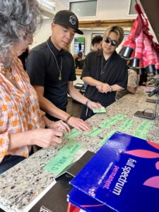 Team at Josephine’s Aveda Salon & Spa in Houston, TX, carefully prepares client details at the counter, showcasing premium hair services and luxury care with “full spectrum permanent” products. | Josephine's Salons and Spas | Houston, TX